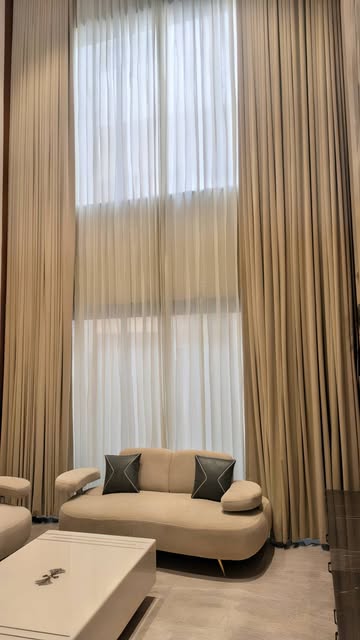Bespoke floor-to-ceiling curtains in a Bhawna Handloom living room